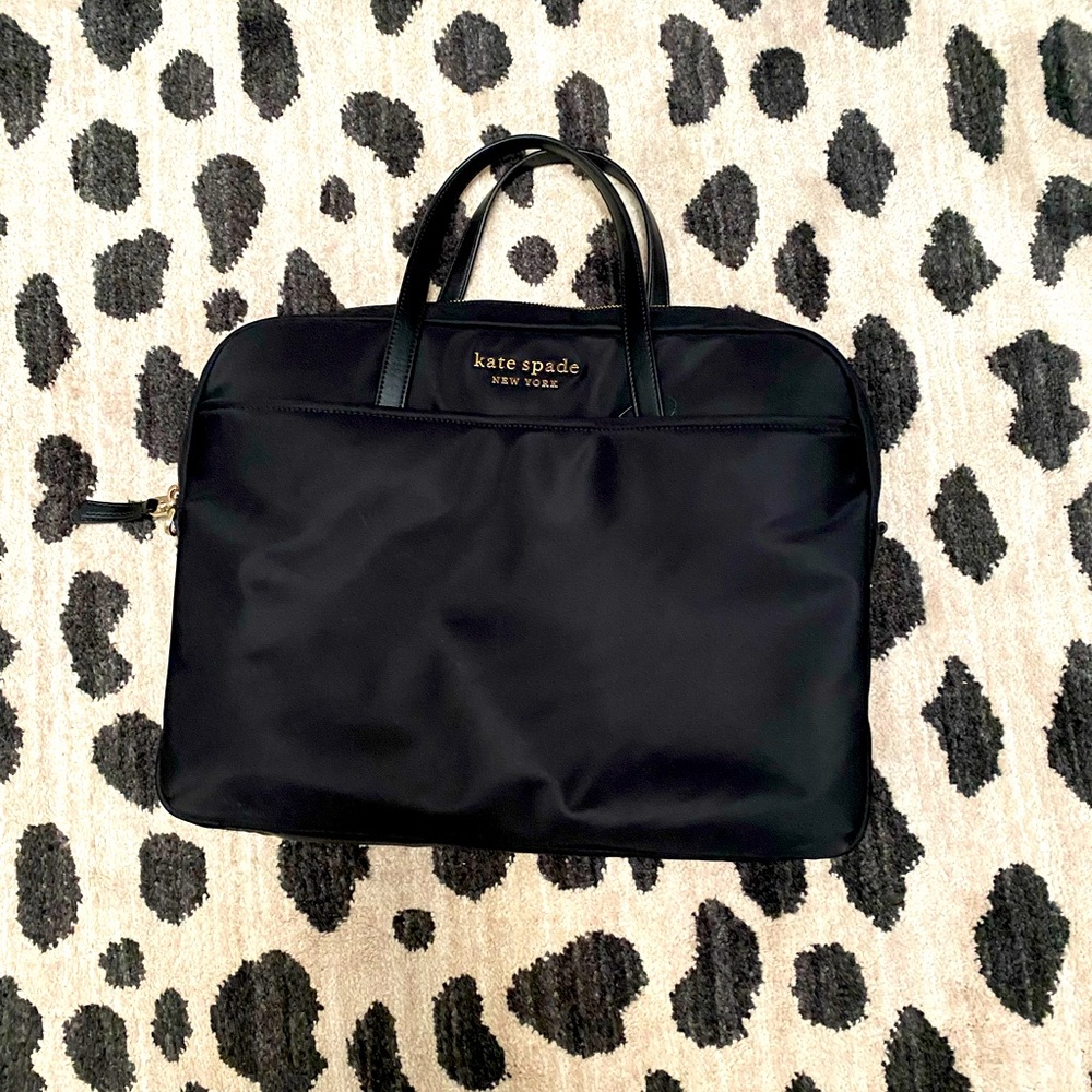 Kate Spade nylon laptop case. It does not have the strap/missing ring